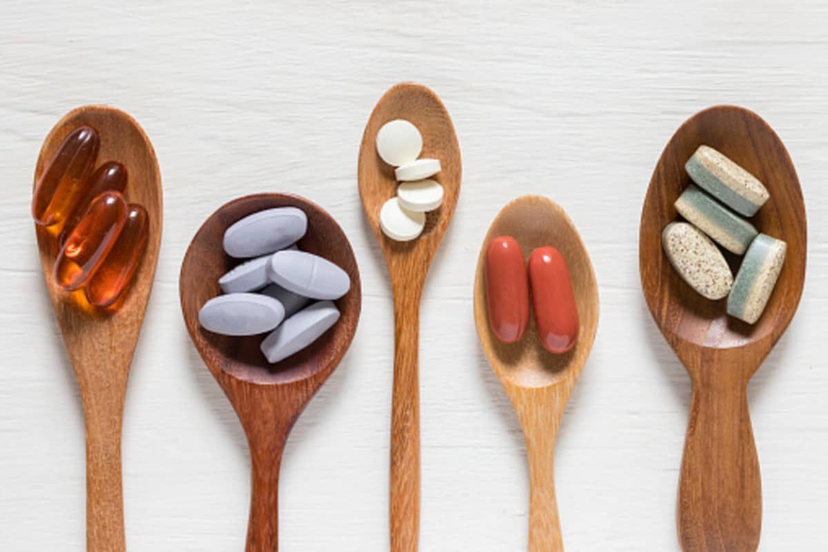 Pills in wooden spoons