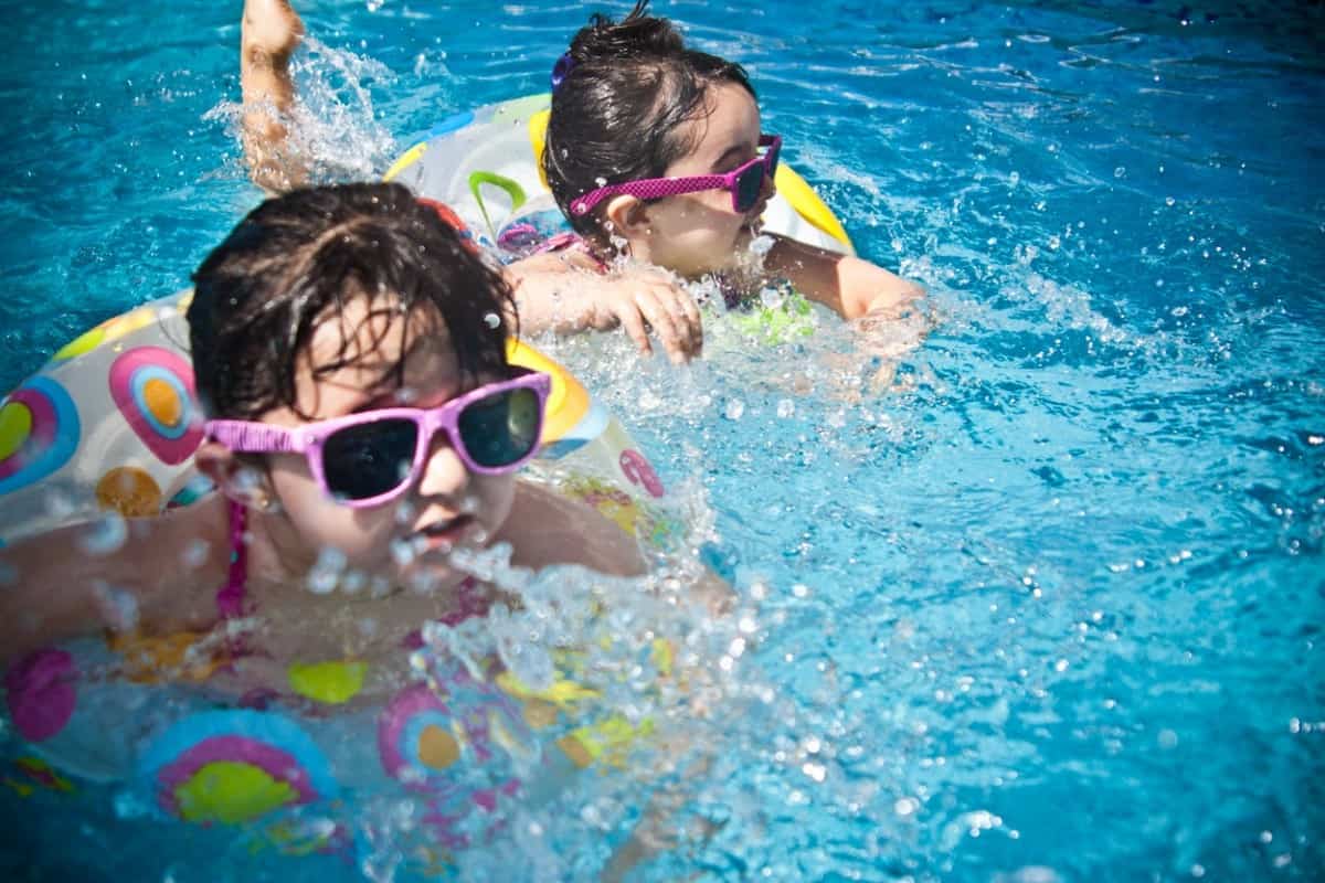 kids swimming with shades and tubes